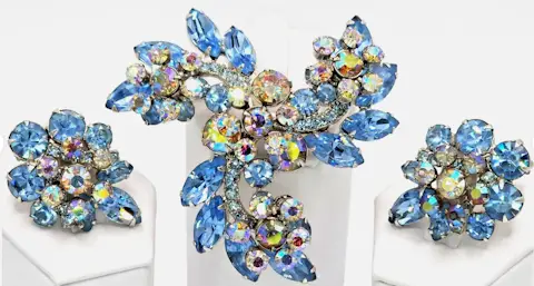 sparkly light blue and aurora borealis brooch and clip earring set - the brooch is shaped like a pinwheel
